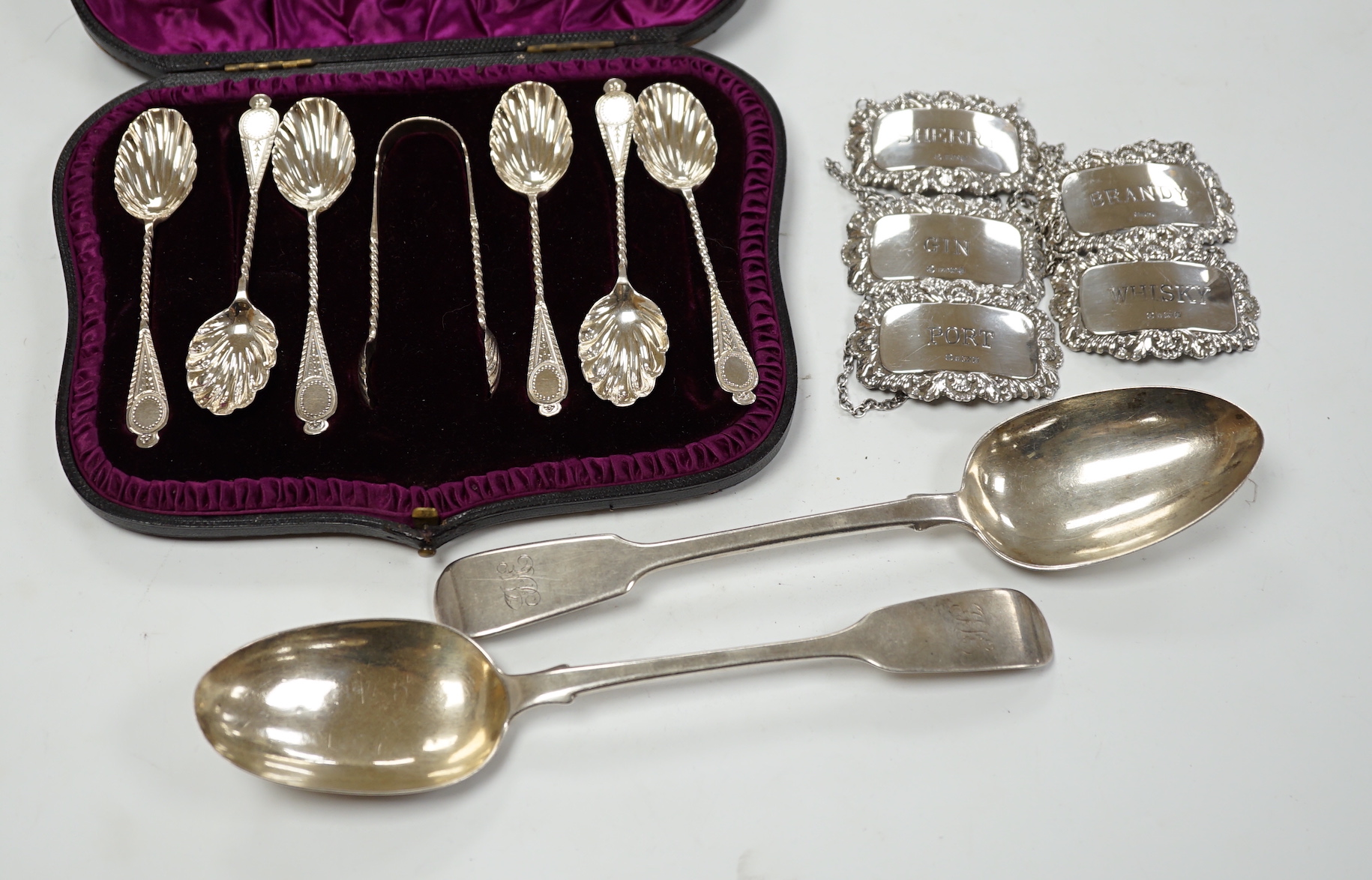 A matched set of five modern silver wine labels, Ray Hall, Sheffield, 1994(3), 1998 & 2000, 61mm, together with two Victorian silver fiddle pattern table spoons, London, 1856 & 1865 and a cased set of six silver coffee s